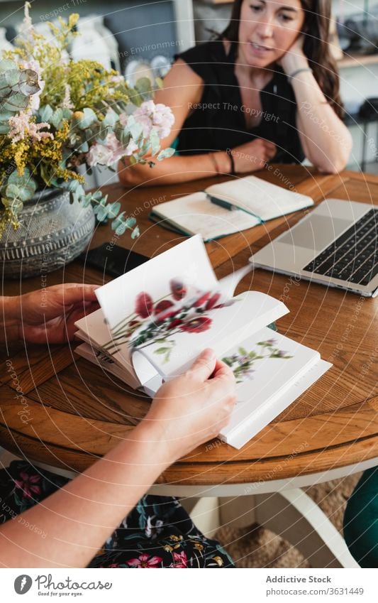 Frauen wählen Blumen aus dem Katalog Floristik katalogisieren Arbeit Orden geblümt Pflanze professionell Salon Job Beruf Kleinunternehmen Stil Unternehmer