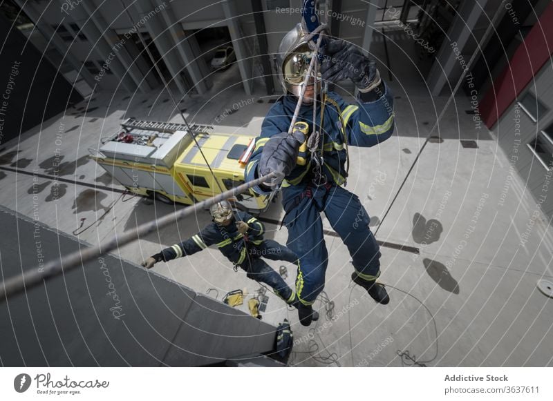 Feuerwehrleute in Uniform mit Seilen in der Ausbildung Feuerwehrmann Training Aufstieg Feuerwehrmänner geräumig Gerät retten komplex üben Gesundheit stark