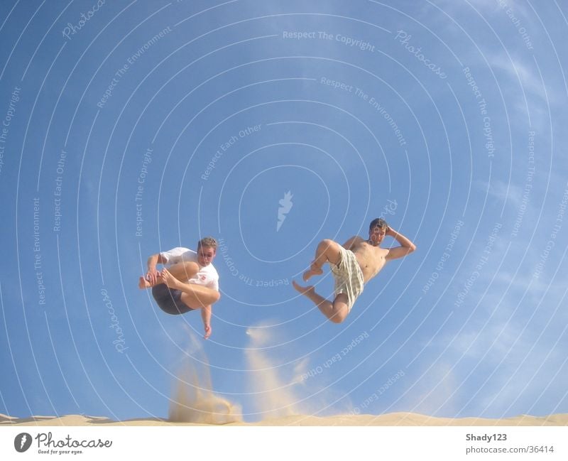 together on the sand Ferien & Urlaub & Reisen springen Strand Sand Himmel blau