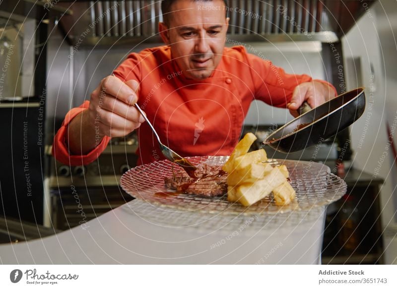 Küchenchef serviert Rinderfilets mit Bratkartoffeln im Restaurant dienen Mahlzeit Rindfleisch Filet gebraten Kartoffel lecker Abendessen Feinschmecker