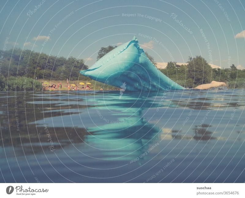 aus dem wasser ragende blaue luftmatratze und ein bein Sommer See baden zu hause bleiben Urlaub zu Hause Seebad schwimmen nass Abkühlung Jugendliche Coronakrise