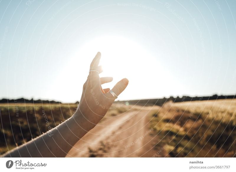 Arm in der Nähe des Sonnenlichts erhoben Hand Hintergrundbeleuchtung Sonnenuntergang Sonnenaufgang schön warm Poesie Windstille ruhig Natur berühren sonnig