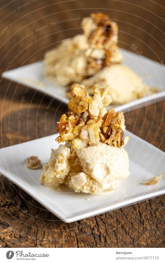 Mandeleis auf dunklem Holz Eis Speiseeis süß Dessert Geschmack Hintergrund Essen Braun weiß cremig lecker Cremeeis kalt gefroren Schaufel Glas frisch Salon