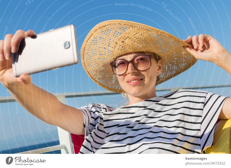 Schöne, romantische blonde Frau, die in den Sommerferien auf der Fahrt mit der Fähre von Cruse ein Selbstporträtfoto macht. Selfie Mädchen Fährschiff Foto