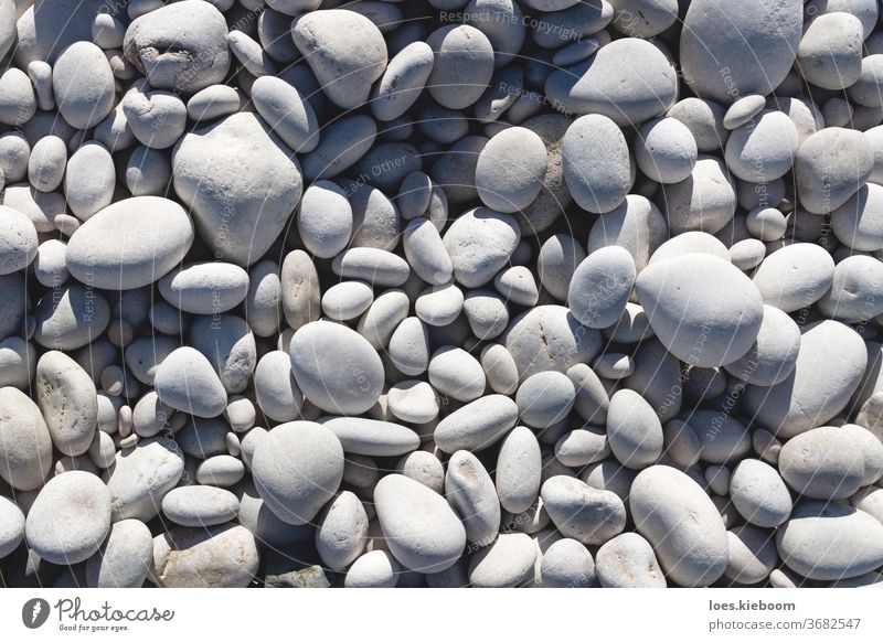 Nahaufnahme von strahlend weißen und grauen Steinen an einem Strand Natur Kieselsteine Felsen Hintergrund Material Muster natürlich sanft im Freien Textur Form