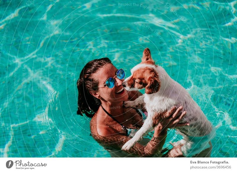 glückliche junge Frau und Hund in einem Schwimmbad, die Spaß haben. Sommerzeit Blauwasser Liebe jack russell Hut Zusammensein Zusammengehörigkeitsgefühl Kuss