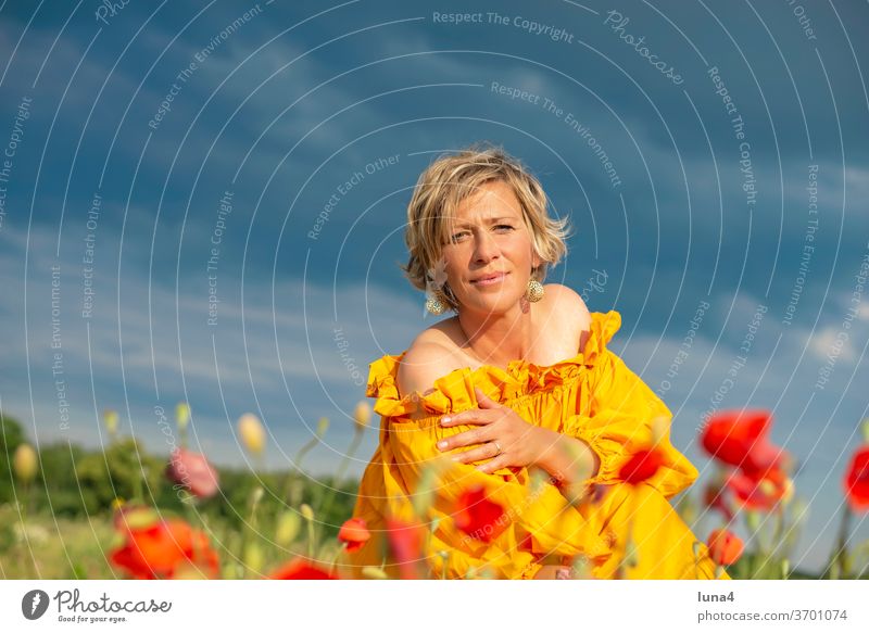 Frau sonnt sich auf Mohnfeld Sonne genießen sonnen lächeln lachen junge Frau sinnlich anmutig Wiese Blumenwiese glücklich fröhlich Auszeit Glück Freude Frühling