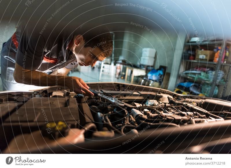 Junger männlicher Mechaniker arbeitet in seiner heimischen Werkstatt Mann Garage Arbeit Männer Erwachsener attraktiv gutaussehend Lebensstile Arbeiter