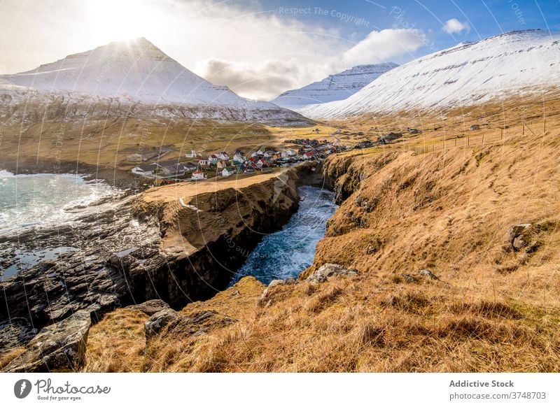 Kleine Siedlung in den Bergen auf den Färöer Inseln Berge u. Gebirge Dorf Wohnsiedlung Winter Schnee Fluss Saison kalt Haus wohnbedingt Färöer-Inseln Landschaft