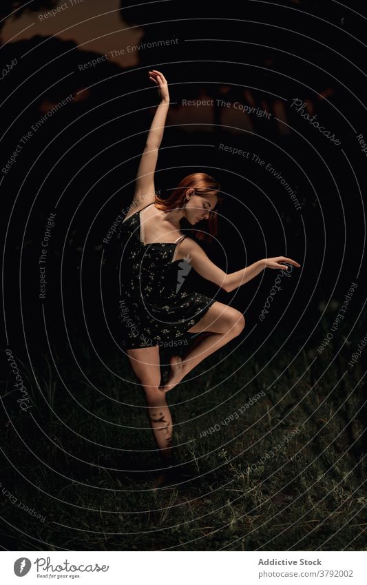 Anmutige Frau tanzt im dunklen Park Balletttänzer Ballerina Tänzer dunkel Wiese Choreographie beweglich Talent Island Kleid Natur elegant Gleichgewicht Künstler