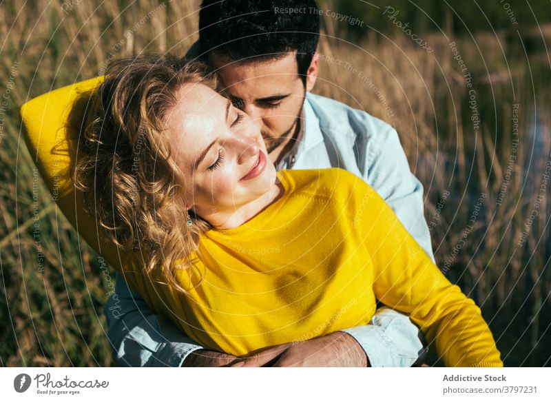 Glückliches Paar umarmt sanft in der Natur Umarmung Liebe Angebot Umarmen Feld sonnig Sommer Partnerschaft Augen geschlossen Freundin Windstille Zusammensein