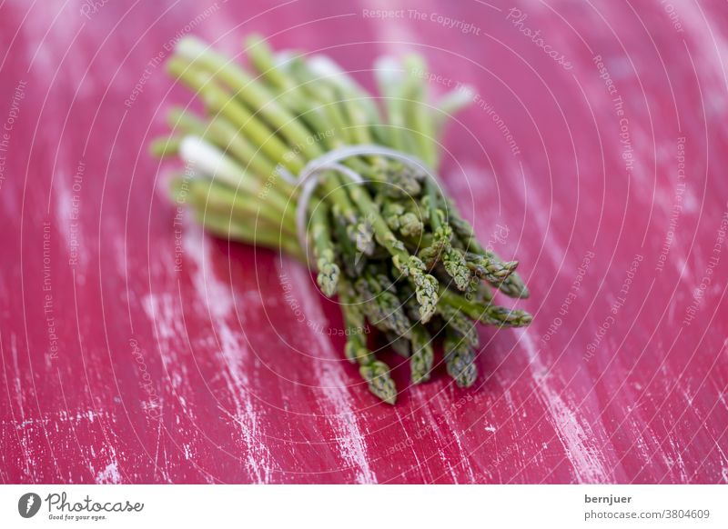 grüner Spargel auf einem roten Tisch Haufen gesund Hintergrund Lebensmittel roh natur Bio Diät Vegetarisch Gemüse Abendessen Kochen frisch lecker Einzelgericht