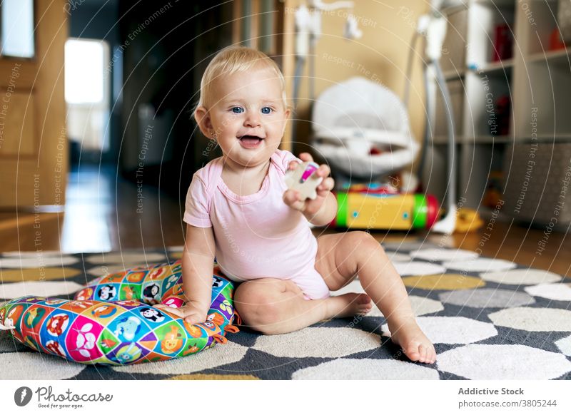 Baby Mädchen spielt auf dem Boden spielen Stock heimwärts Glück Spaß haben Spielzeug Grimasse Liebe Tochter Zusammensein bezaubernd jung Kind Kleinkind