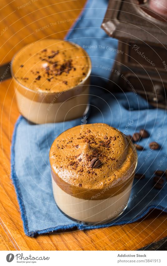 Dalgona-Kaffee in Glastassen auf dem Tisch dalgona Café Bierschaum Erfrischung dienen kalt schäumen Aroma Schokolade Garnierung sofort trinken Getränk melken