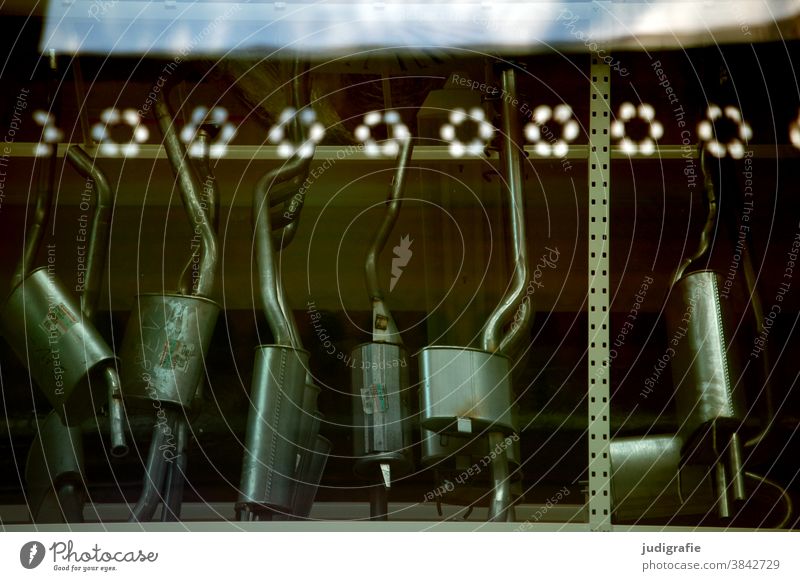 Ersatzteile: Auspuffauswahl im Schaufenster. auspufftopf Auspuffrohr ersatzteillager Dekoration Technik Spiegelung Auswahl Fenster Ladengeschäft