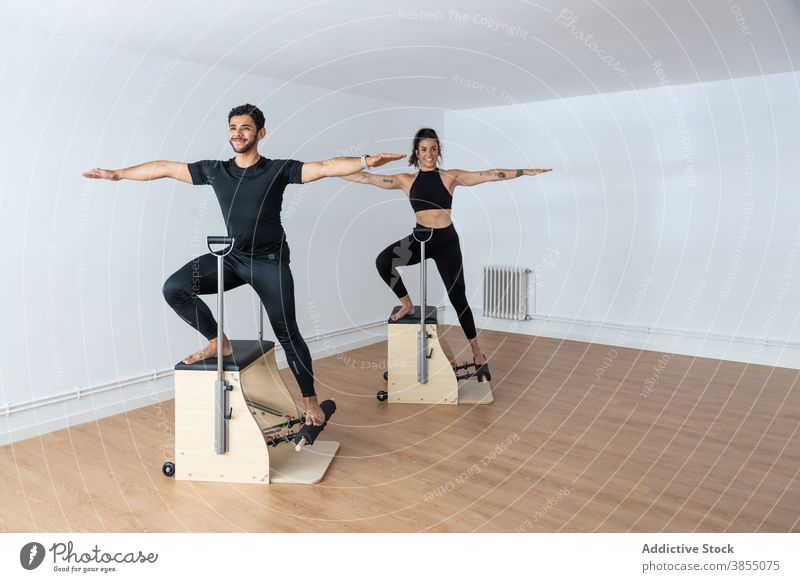 Sportler bei Übungen während des Pilates-Trainings Stuhl üben Sportlerin Fitnessstudio passen Barfuß hell Gesundheit schlank Athlet Energie Kraft Bestimmen Sie