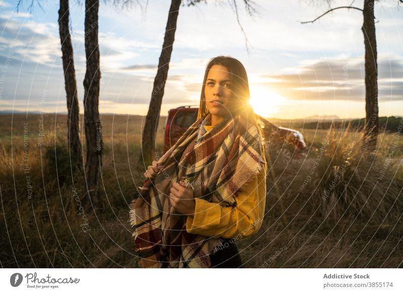 Frau in warmem Plaid im Feld umhüllen Sonnenuntergang Herbst genießen sich[Akk] entspannen Decke trocknen Windstille friedlich ruhig Natur Freiheit Abend