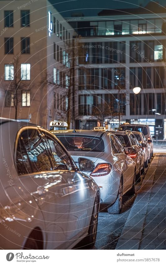 Taxis die auf Kundschaft warten Taxifahrer Taxistand Nacht Licht München Berufsverkehr wartend aufgereiht Abend Nachtleben Straße Warteschlange Kreuzung