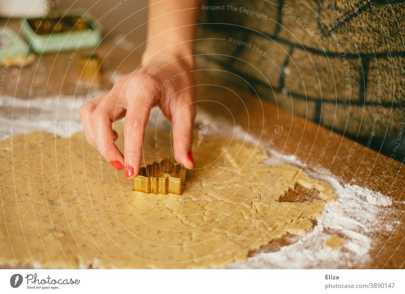 Weihnachtsbäckerei - Eine Frau Sticht Plätzchen in Tannenbaumform aus Teig aus backen Weihnachtsplätzchen Tannenbäume Plätzchen backen Weihnachtsgebäck