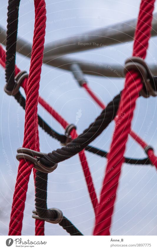 Kletterkarussell Freude Spielen Spielplatz grau kalt rot schwarz Metall Festhalten Schwung Aussicht Halt Sicherheit Sicherung Abgesichert Drehscheibe Klettern