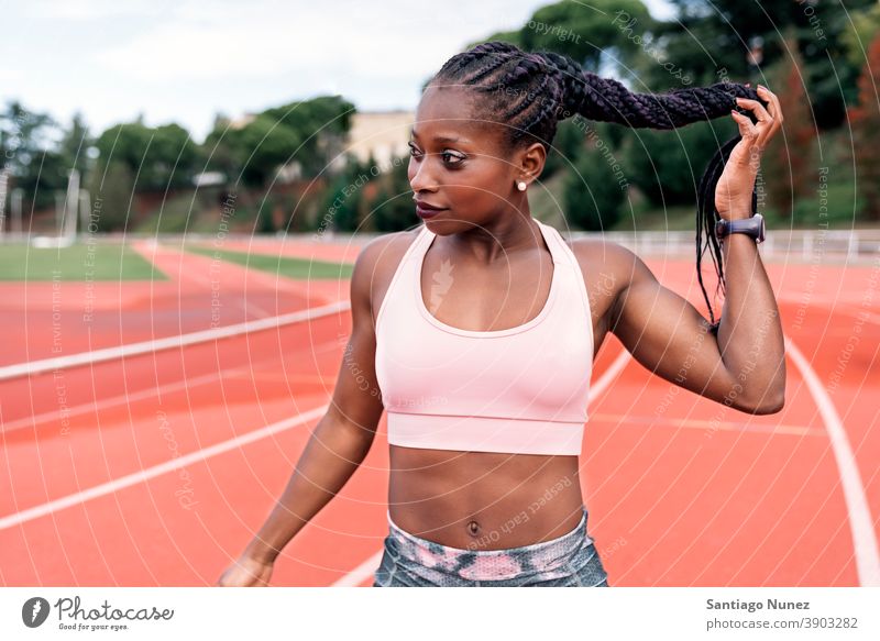 Athlet Sprinter berührt geflochtenes Haar Frau Bahn Leichtathletik Läufer rennen Konkurrenz passen Rennbahn Stadion Training Aktion sportlich Fitness Sport