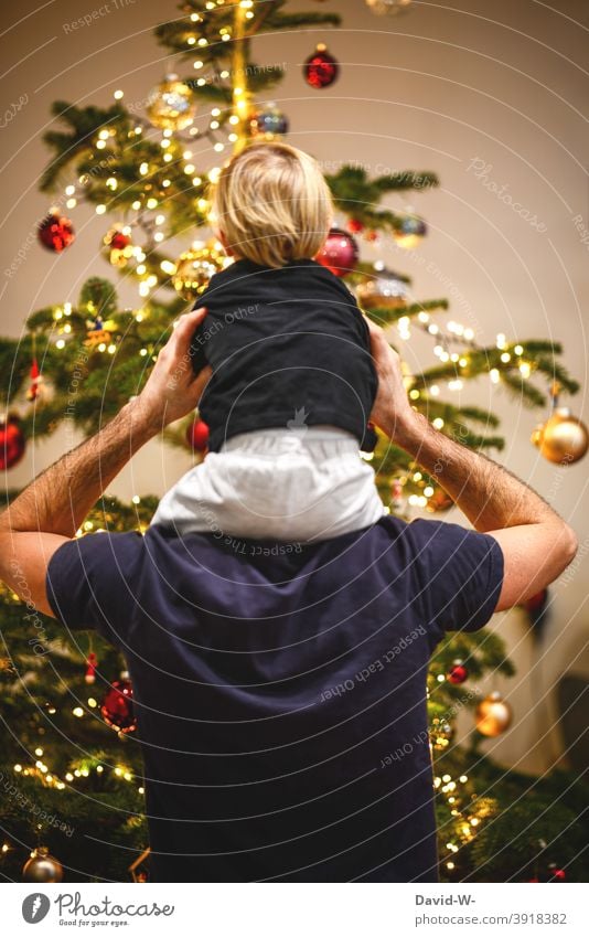 Vater und Kind vor dem geschmückten Weihnachtsbaum Weihnachten & Advent Familie Heiligabend Zusammensein Eltern Freude Gemeinsam glücklich