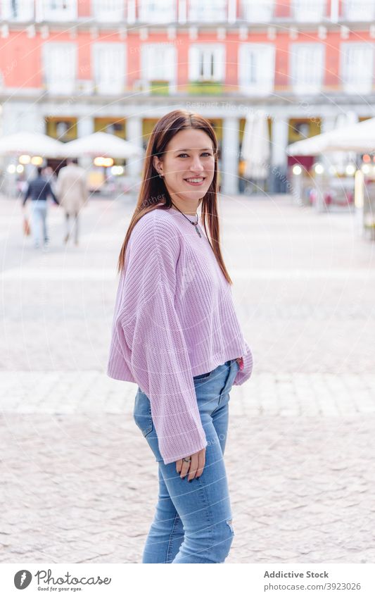 Frau in Freizeitkleidung lächelnd in die Kamera in der Stadt lässig Outfit Lächeln Straße Großstadt charmant heiter Wochenende jung Stil urban Glück modern