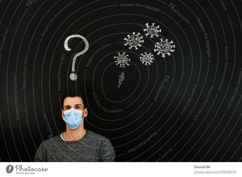 Coronavirus - Mann denkt über Corona nach coronavirus mutation denken Gedanken ? Fragezeichen Virus Zukunft Angst Zukunftsangst pandemie Mundschutz