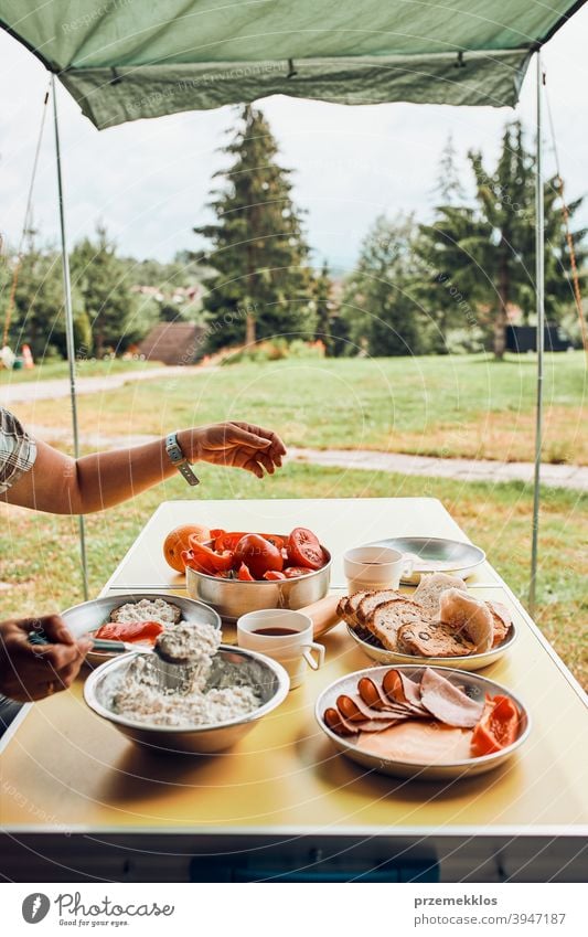 Frühstück in den Sommerferien auf dem Campingplatz zubereitet authentisch wirklich Banane gekochtes Fleisch langsames Leben Tischdecken im Freien