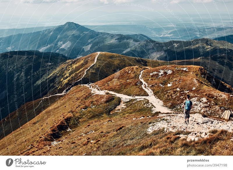 Junger Mann mit Rucksack Wandern in einem Gebirge, aktiv verbringen Sommerurlaub Aktivität Abenteuer Freiheit Gesundheit Freude Freizeit Natur Park Erholung