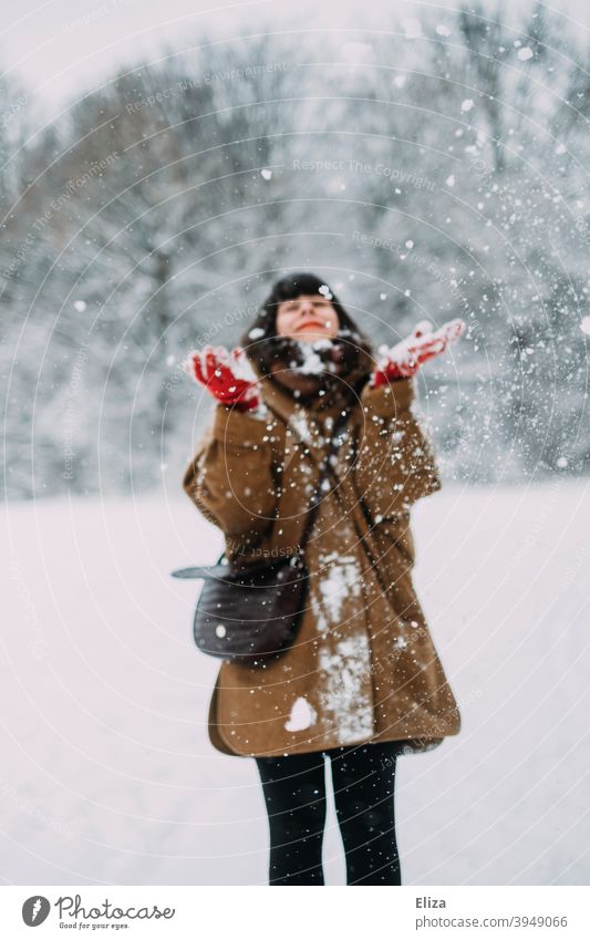 Schneeverliebt im Winter - Eine junge Frau steht im Schnee und lacht vor Freude lachen winterlich brünett Lebensfreude Schneelandschaft verschneit spielen