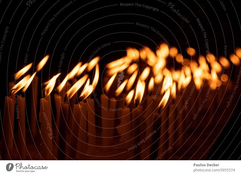 Zahlreiche flackernde Gebetskerzen, monochrom Kerzen beten Flackern Beten Hoffnung Kerzenschein Glaube Religion glauben Frieden Flammen stimmungsvoll brennend