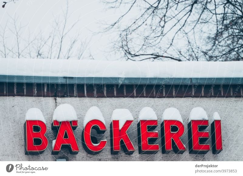 Bäckereischild mit Schnee bedeckt Winterstimmung Winterurlaub ästhetisch außergewöhnlich Textfreiraum Mitte Sonnenlicht Textfreiraum unten Textfreiraum oben