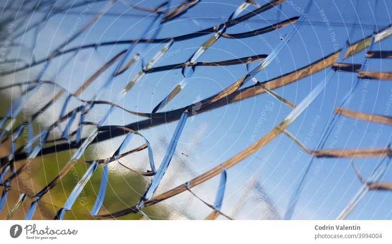 Nahaufnahme der Risse auf dem Glas eines Fensters abstrakt Blauer Himmel Unschärfe gebrochen Absturz Schaden Design Einschlag Landschaft Licht Natur