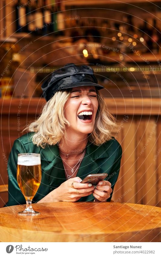 Frau schaut in einer Bar auf ihr Smartphone. Paar Erwachsener Glück Restaurant Lifestyle Kaukasier schön Fröhlichkeit trinken Lächeln Spaß Liebe Freude Feier