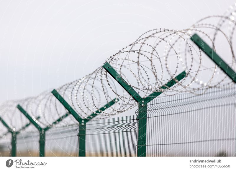 Umzäunung von sensiblen Standorten mit Stacheldraht. Stacheldraht. Einschränkung der Freiheit. Gefängniszaun. Verbotenes Territorium. Das Konzept der Sicherheit. Das Konzept des Verbots.