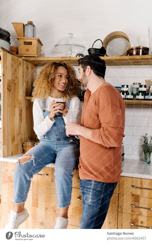 Pärchen lachend und in der Küche stehend. Lebensmitte Paar Liebe Essen zubereiten heimwärts gemütlich Kaukasier Partnerschaft vorbereitend Frau Glück Person