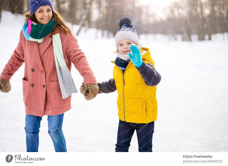 Mutter und Sohn beim Schlittschuhlaufen auf gefrorenem Teich Tochter Saison Zusammensein heiter Spaß Kind Menschen Park Feiertag Wald Kindheit Frau Mädchen