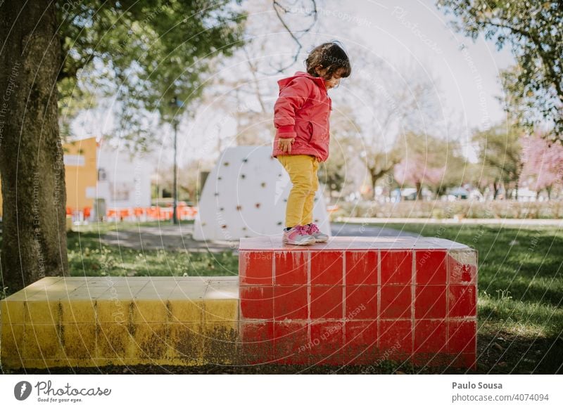 Nettes Mädchen spielt auf dem Spielplatz Kind Kindheit 1-3 Jahre Farbfoto Kaukasier Farbe farbenfroh authentisch im Freien Frühling rosa gelb Mensch