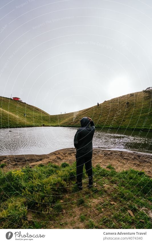 Unbekannter Mann vor einem Vulkansee, der sich umschaut Landschaft Berge u. Gebirge Natur reisen Baum Himmel im Freien schön Nebelwald Wolken Umwelt Wald frisch