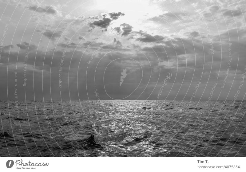 auf der Ostsee segeln bei Wolkigen Himmel aber die Sonne kommt durch Segeln Sonnenlicht bnw Wasser Meer Außenaufnahme Sommer Menschenleer