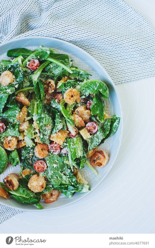 Draufsicht auf leckeren gesunden Salat mit gegrillten Garnelen, Kirschtomaten und Crostini Salatbeilage Lebensmittel Granele Mittagessen Abendessen Gemüse