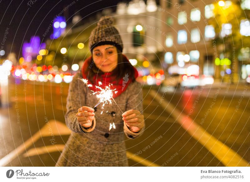 schöne junge Frau, die in der Nacht funkelt, Spaß hat und lächelt Party Licht dunkel Feuer Feuerwerk Hand Flamme Funkelt hell Lebensstile Hintergrund Glück