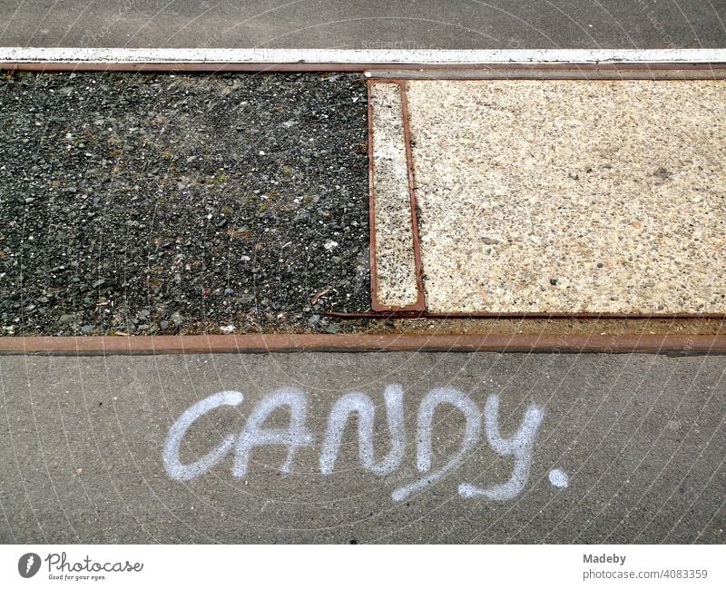 Rostige alte Schienen mit Schotter, grauem Asphalt und Graffiti CANDY am alten Hafen in Offenbach am Main in Hessen Gleise Binnenhafen Transport Verkehr