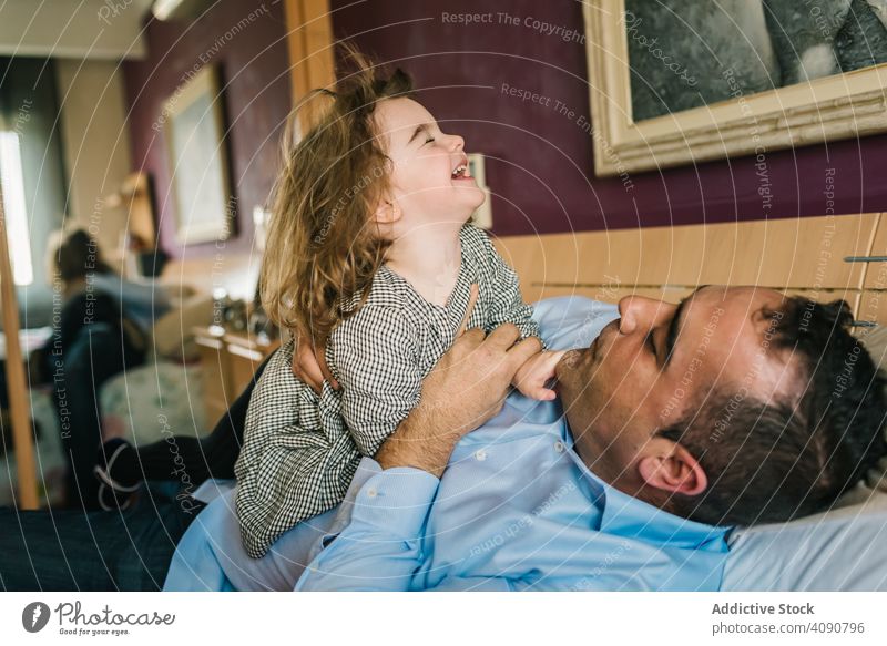 Vater spielt mit Tochter Spaß haben Liebe spielerisch umarmend Eltern Fröhlichkeit heimatlich Gefühle jung Mann Kind lieblich Freizeit genießen Lachen heiter