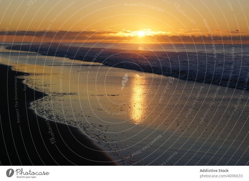 Farbenfroher Sonnenuntergang über friedlichem Meeresufer farbenfroh wolkig ruhig Strand sandig winken Spanien Gran Canaria Maspalomas Horizont Wolkenlandschaft