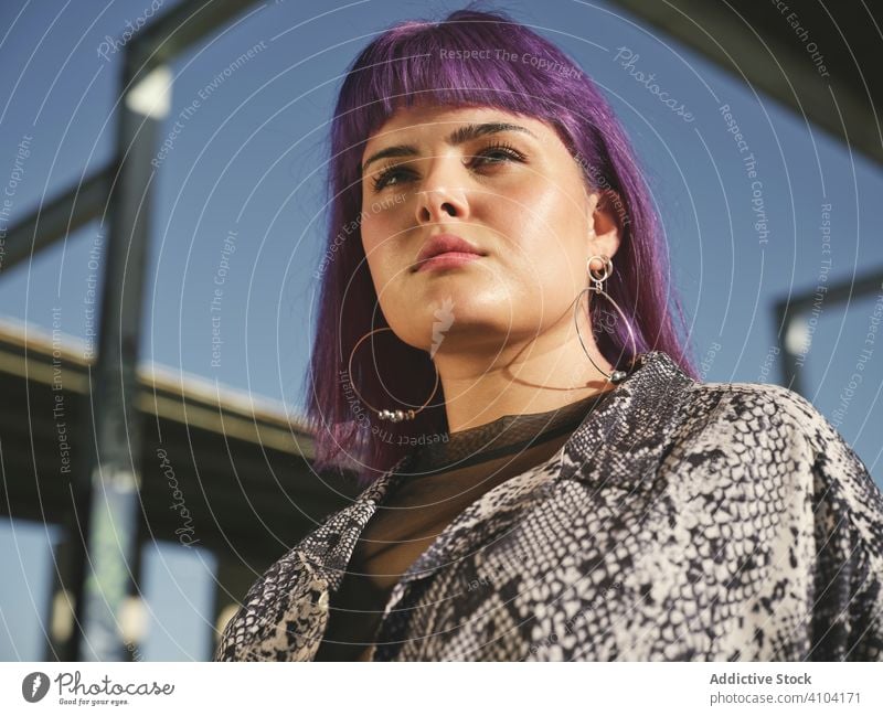 Frau mit lila Haaren auf der Straße stylisch urban purpur Frisur Konstruktion glänzend Struktur Revier selbstbewusst Mode jung Stil Model menschlich Außenseite