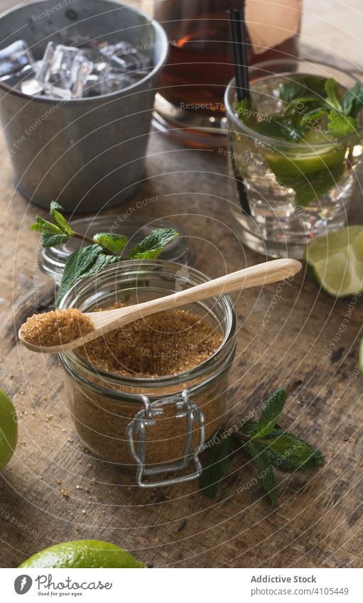 Frische Zutaten für die Mojito-Zubereitung Bestandteil Vorbereitung Kalk Pfefferminz Brauner Zucker Rum Serviette Tisch Cocktail Getränk trinken Minze Blatt