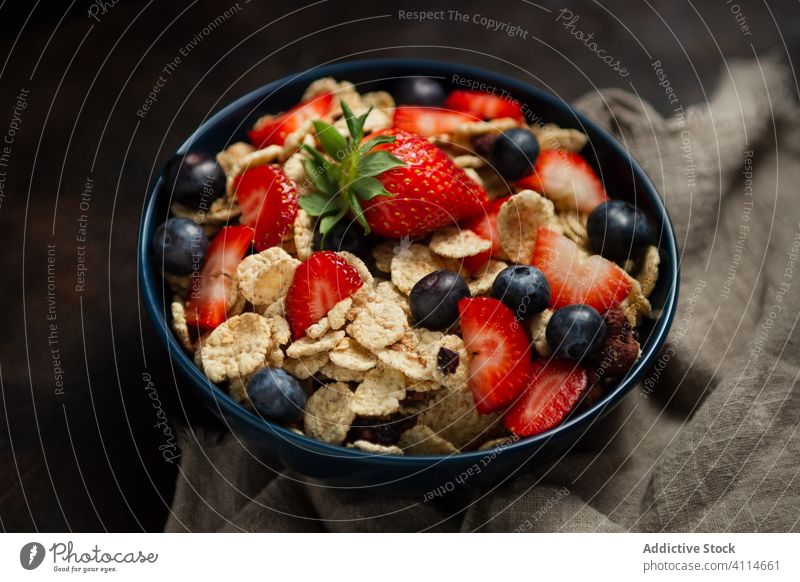 Frische Cornflakes mit Erdbeeren und Blaubeeren auf dem Holztisch Frühstück Müsli lecker Tisch frisch Schalen & Schüsseln organisch Gesundheit Ernährung Beeren