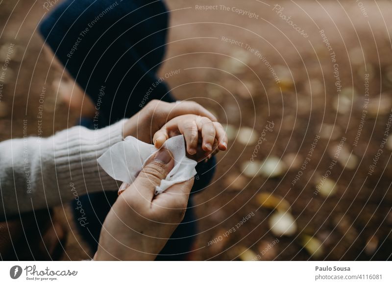 Nahaufnahme Mutter reinigt Kind Hand mit Wischtuch Wischen Sauberkeit dreckig Reinigen Farbfoto Finger weiß Mutterschaft Mutter mit Kind Pflege Zusammensein